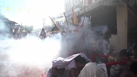 Firecracker explosions during the Phuket vegetarian festival. Stock Footage 261960989