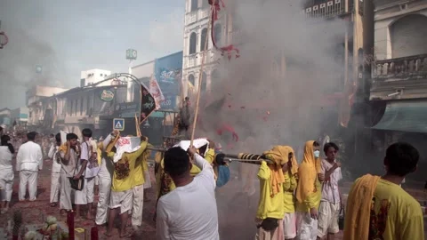 Firecracker explosions during the Phuket vegetarian festival. Stock Footage 261989063