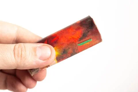 Firecracker with a wick in hand on a white background, isolate, close-up. Copy Foto stock