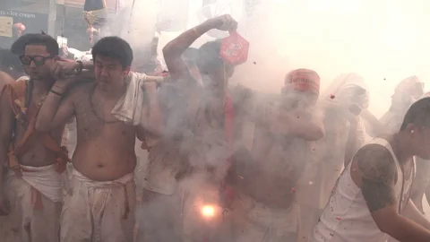 Firecrackers explode over devotees of Chinese shrine. Video stock 120030124