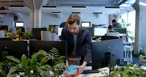Fired Caucasian man coming to table at working place and taking things. Male Stock Footage 180003546