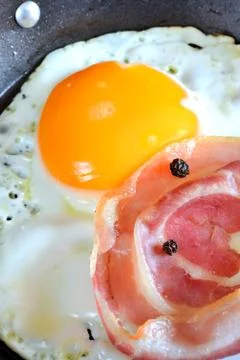 Fired egg with bacon Stock Photos
