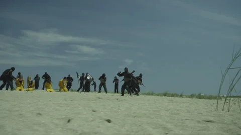 Firefight over Muslim Terrorists, Executing Prisoners on a Shore. Stock Footage 59117311