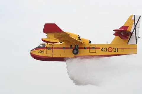 Firefighter Airplane ejecting water load Stock Photos