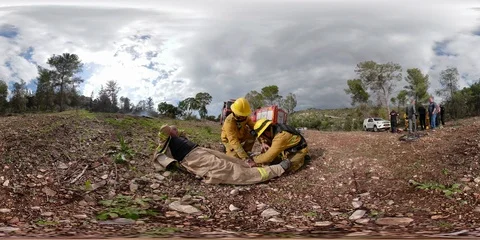 Firefighter and paramedic provide first aid to an injured firefighter 360VR 스톡 동영상 99756988