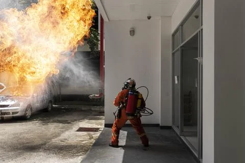 Firefighter with backpack fire extinguishing gun. Emergency Fire Rescue. Stock Photos