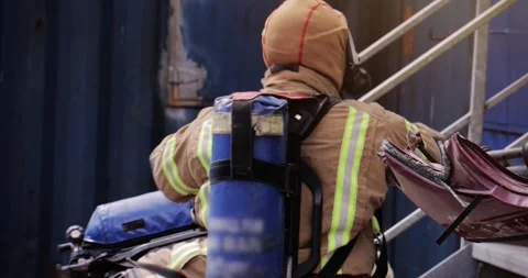 Firefighter with breathing apparatus - fire men in action with uniform Stock Footage 345057708