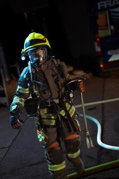 Firefighter carying a crowbar Stock Photos