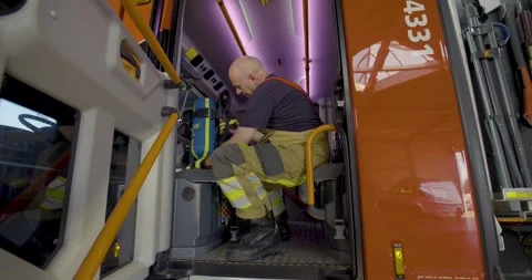 Firefighter checking their breathing apparatus inside the fire truck Video stock 250004312