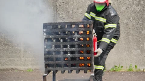 Firefighter conducting a training exercise. Fireman putting out fire Stock Footage 276737367