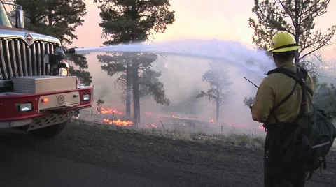 Firefighter controlling hose on front of fire truck Stock Footage 40751223