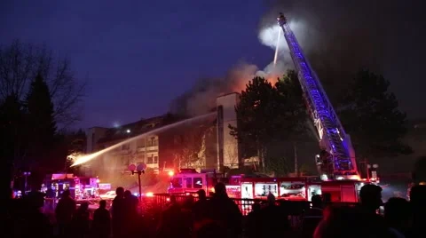 Firefighter crews battling apartment complex fire at night Stock Footage 48472274