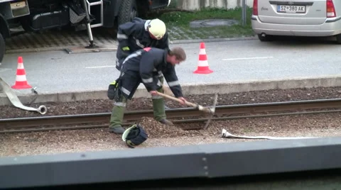 Firefighter digs under train rails Stock Footage 5946187