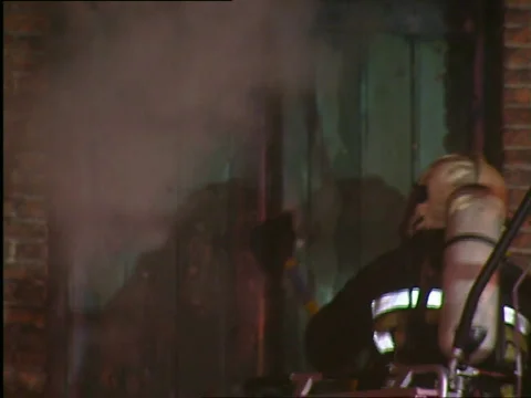 Firefighter entering warehouse on fire Stock Footage 655380
