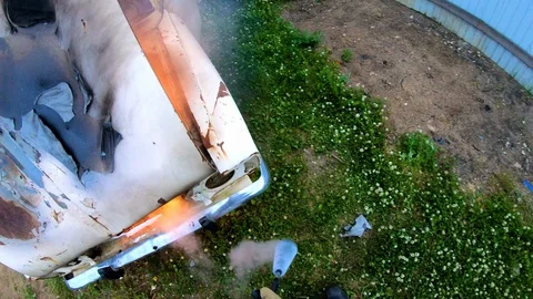 Firefighter extinguishes a burning car with a fire extinguisher. Stock Footage 112706345