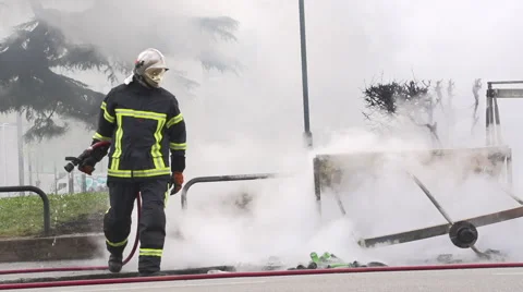 Firefighter extinguishing fire Stock Footage 62505459