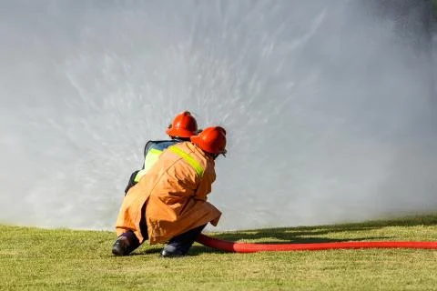 Firefighter fighting for fire attack training Stock Photos
