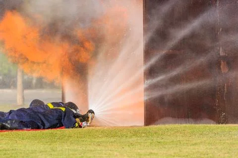Firefighter fighting for fire attack training Stock Photos
