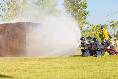 Firefighter fighting for fire attack training Stock Photos