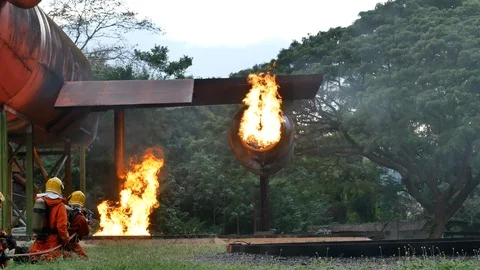 Firefighter fighting with fire flame protection property. Fireman wear hard hat, Stock Footage 112170680
