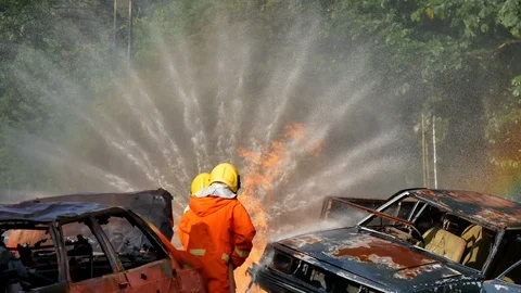 Firefighter fighting with fire flame protection property. Fireman wear hard hat, Stock Footage 112737973