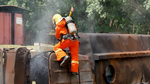 Firefighter fighting with fire flame protection property. Fireman wear hard hat, 스톡 동영상 124119191