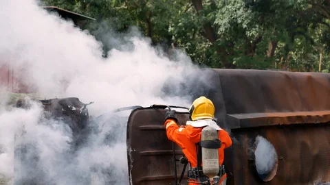 Firefighter fighting with fire flame protection property. Fireman wear hard hat, Video stock 124127147