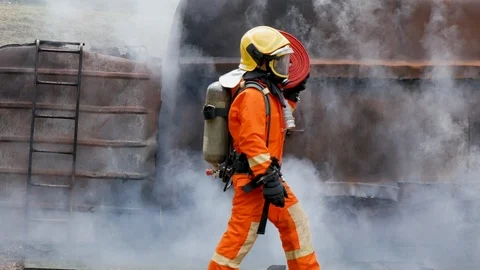 Firefighter fighting with fire flame protection property. Fireman wear hard hat, 库存影片 124183337