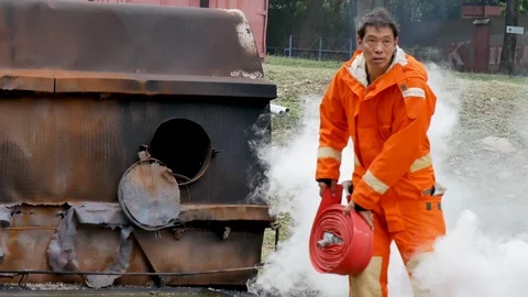 Firefighter fighting with fire flame protection property. Fireman wear hard hat, Video stock 124202686