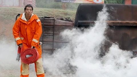 Firefighter fighting with fire flame protection property. Fireman wear hard hat, Video stock 124202909