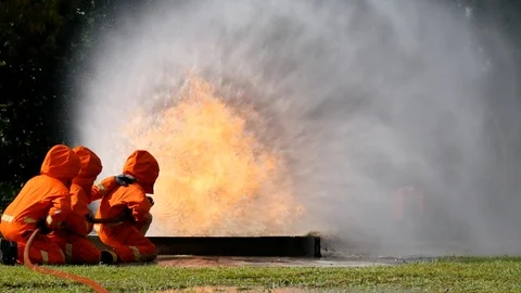 Firefighter fighting with fire flame protection property. Fireman wear hard hat, 스톡 동영상 124564137