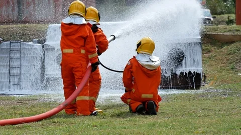 Firefighter fighting with fire flame protection property. Fireman wear hard hat, Stock Footage 124564556