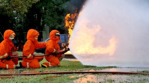 Firefighter fighting with fire flame protection property. Fireman wear hard hat, Stock-Footage 124565344