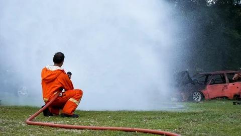 Firefighter fighting with fire flame protection property. Fireman wear hard hat, Stock-Footage 124567830