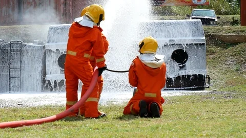 Firefighter fighting with fire flame protection property. Fireman wear hard hat, Stock-Footage 124569092