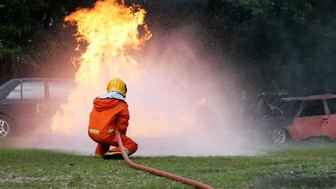 Firefighter fighting with fire flame protection property. Fireman wear hard hat, 库存影片 124569197