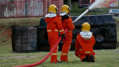 Firefighter fighting with fire flame protection property. Fireman wear hard hat, Stock Footage 151008298