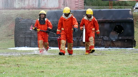 Firefighter fighting with fire flame protection property Stock Footage 270101776