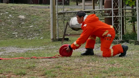 Firefighter fighting with fire flame protection property Видео 270101864