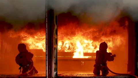 Firefighter fighting with fire flame protection property Видео 270102996