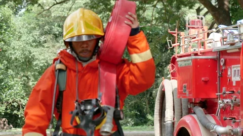 Firefighter fighting with fire flame protection property Видео 270104834