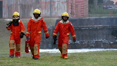 Firefighter fighting with flame using fire hose chemical water foam spray engine Vidéo 154354449