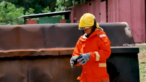 Firefighter fighting with flame using fire hose chemical water foam spray engin Video stock 254135929