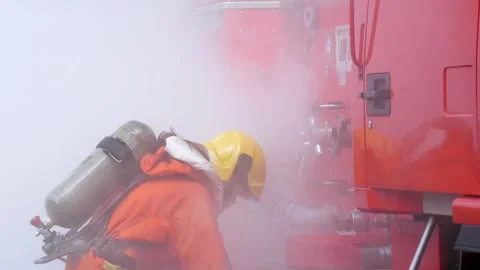 Firefighter fighting with flame using fire hose chemical water foam Stock-Footage 337748406