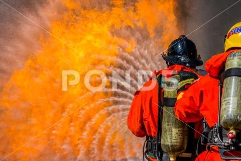 Firefighter in fire fighting operation Stock Photos