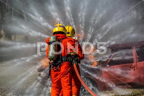 Firefighter in fire fighting operation Stock Photos