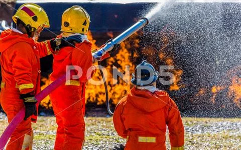 Firefighter in fire fighting operation Stock Photos