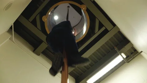 A firefighter in a fire station slides down a pole to answer an emergency Stock-Footage 232650054