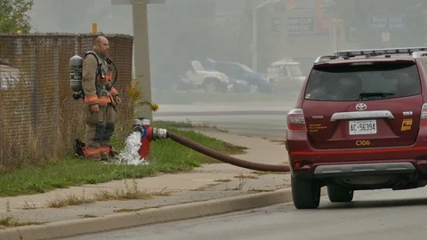 Firefighter Flushing Out Hydrant During Industrial Fire - 24fps 1080p Stock Footage 91566352