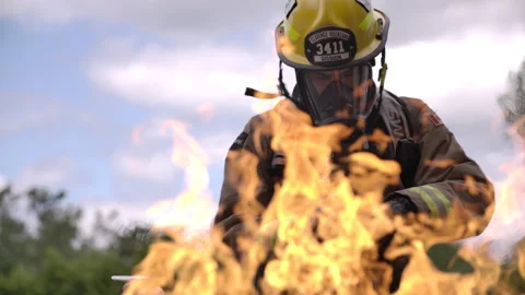 Firefighter in front of a blaze fighting the fire Stock Footage 299162871
